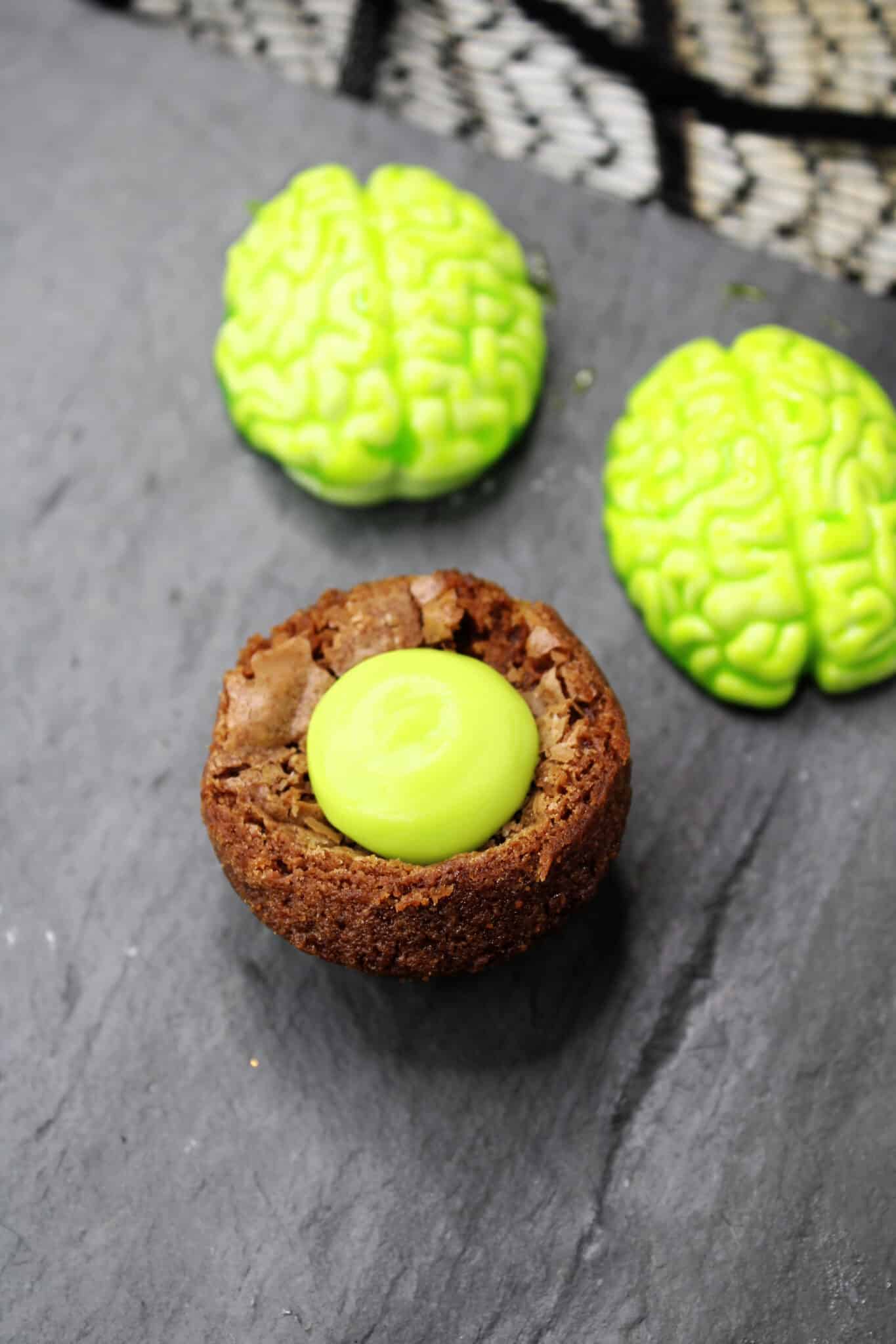 green ganache spooned into a brownie cup